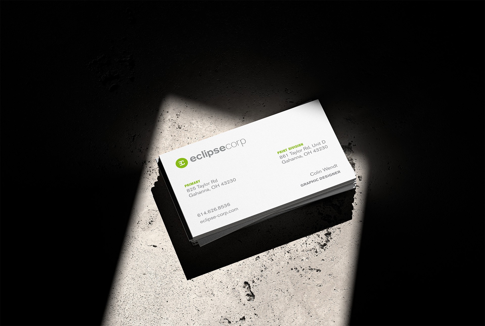 Business cards mocked up with dramatic lighting.